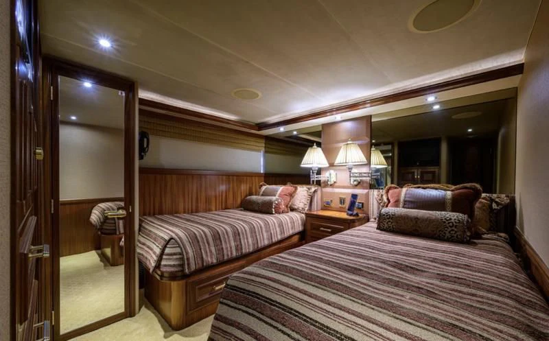 a hotel room with a bed and a couch aboard SYMPHONY Yacht for Sale