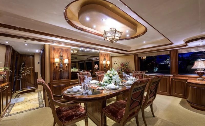 a dining room with a table and chairs aboard SYMPHONY Yacht for Sale