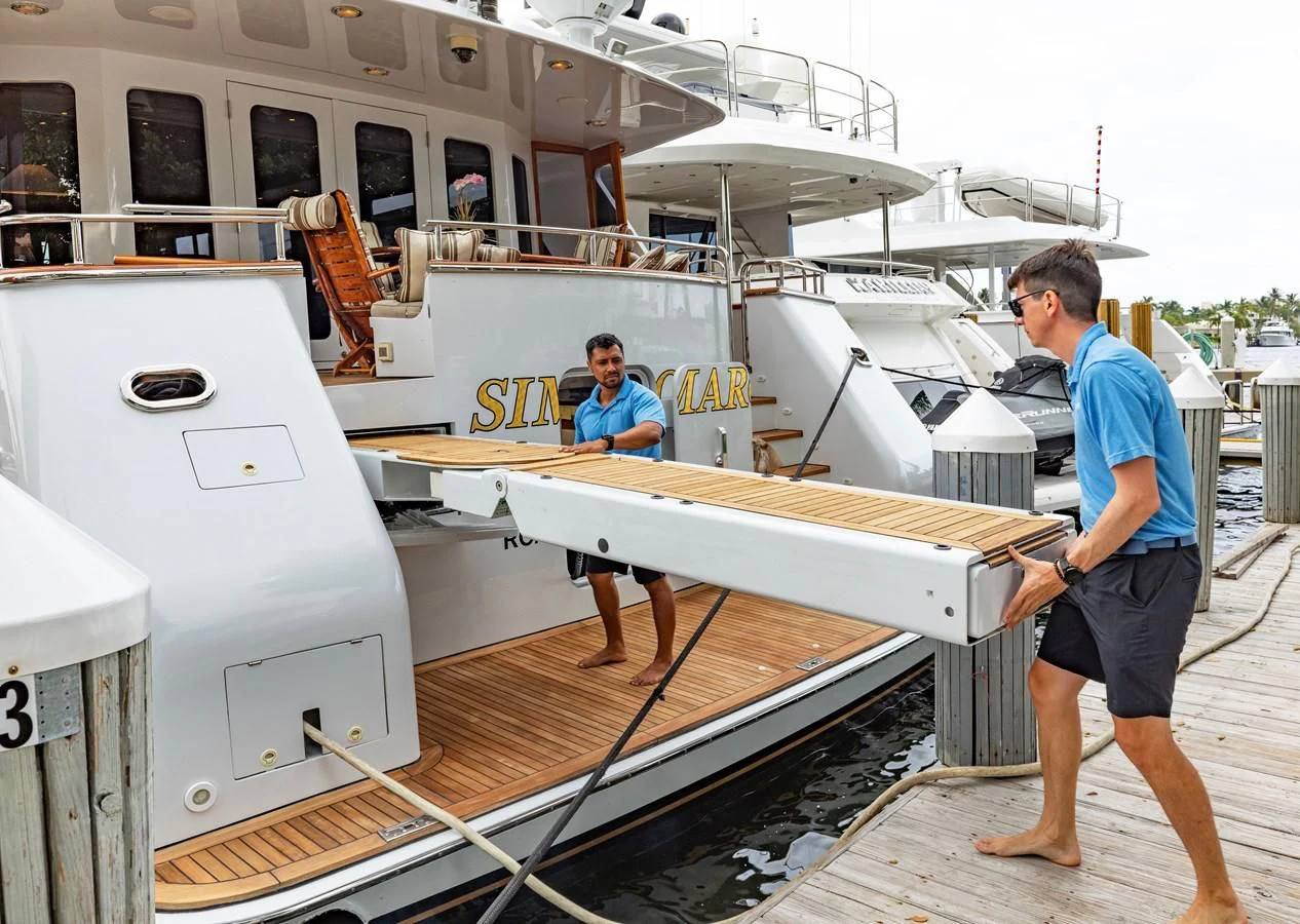 a couple of men standing on a boat aboard SIMARON Yacht for Sale