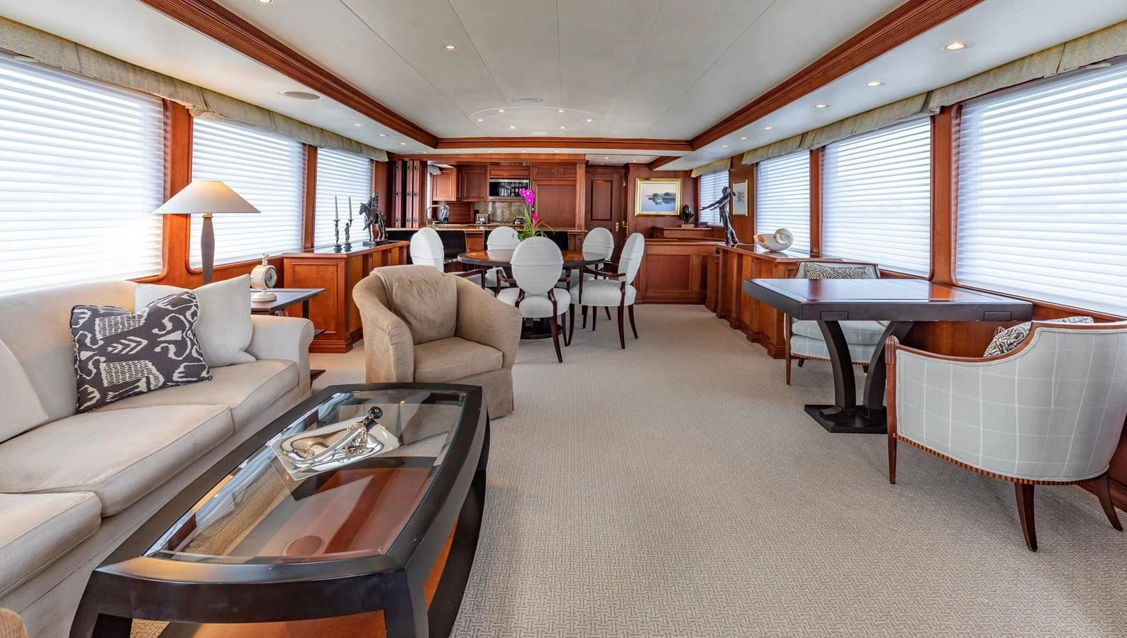 a living room with a piano and a table aboard SIMARON Yacht for Sale