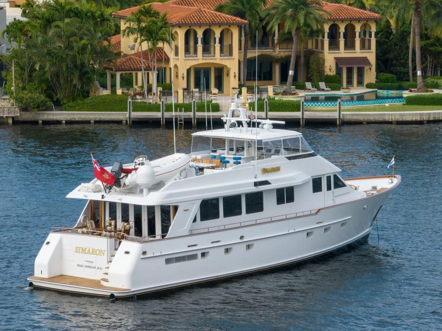 a white boat on a dock aboard SIMARON Yacht for Sale