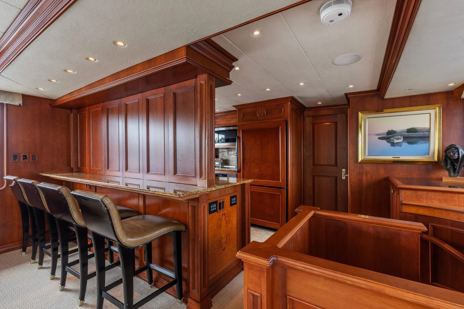a room with a bar and chairs aboard SIMARON Yacht for Sale