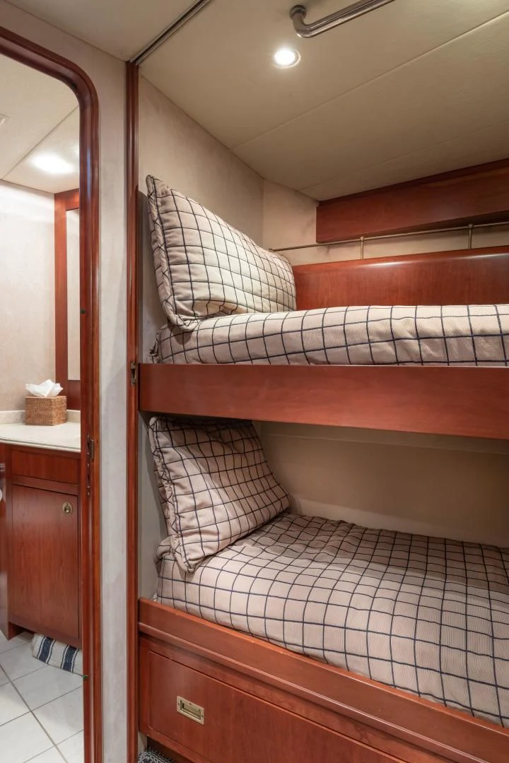 a bed with a striped blanket aboard SIMARON Yacht for Sale