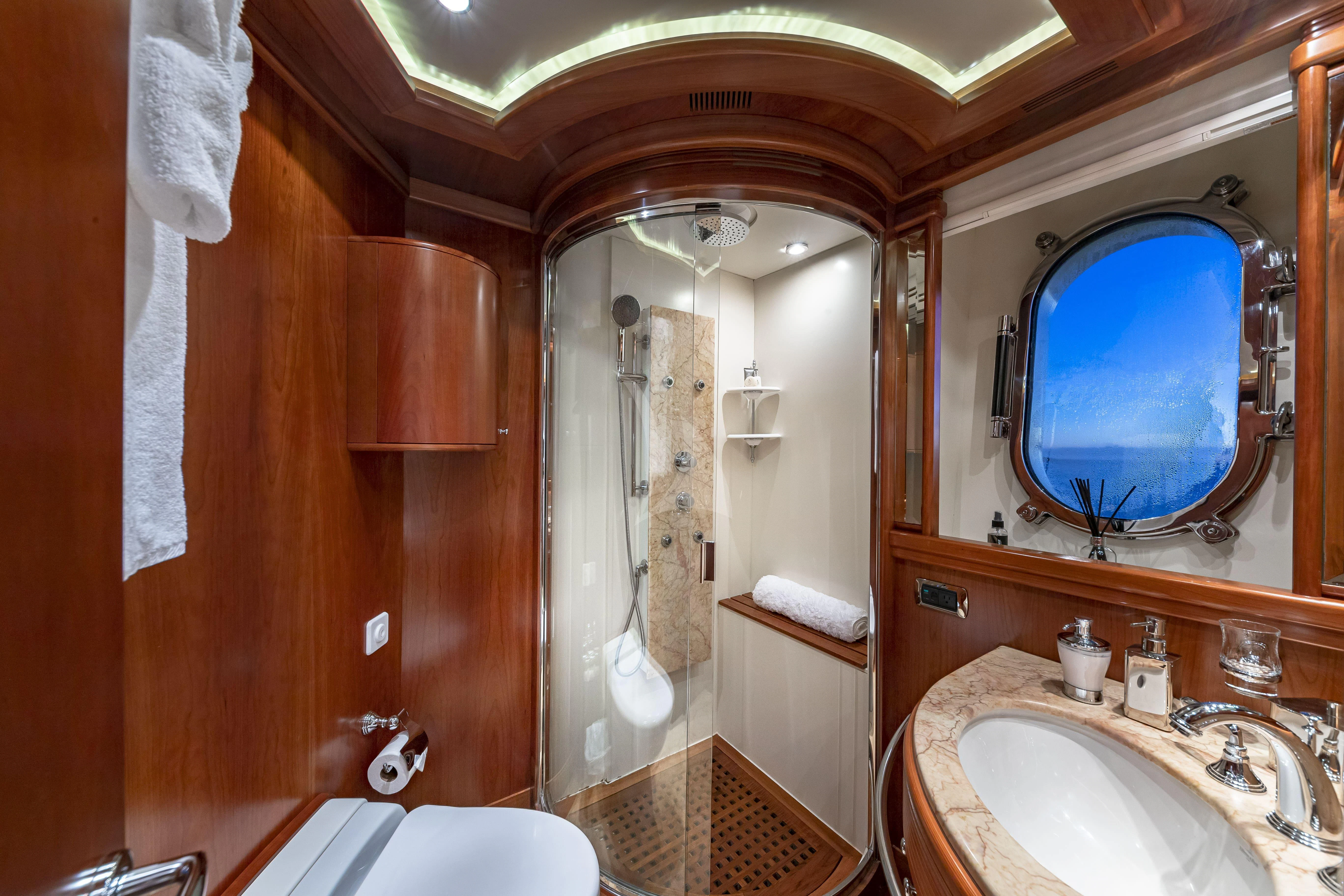 a bathroom with a large mirror aboard SWEET EMOCEAN Yacht for Sale