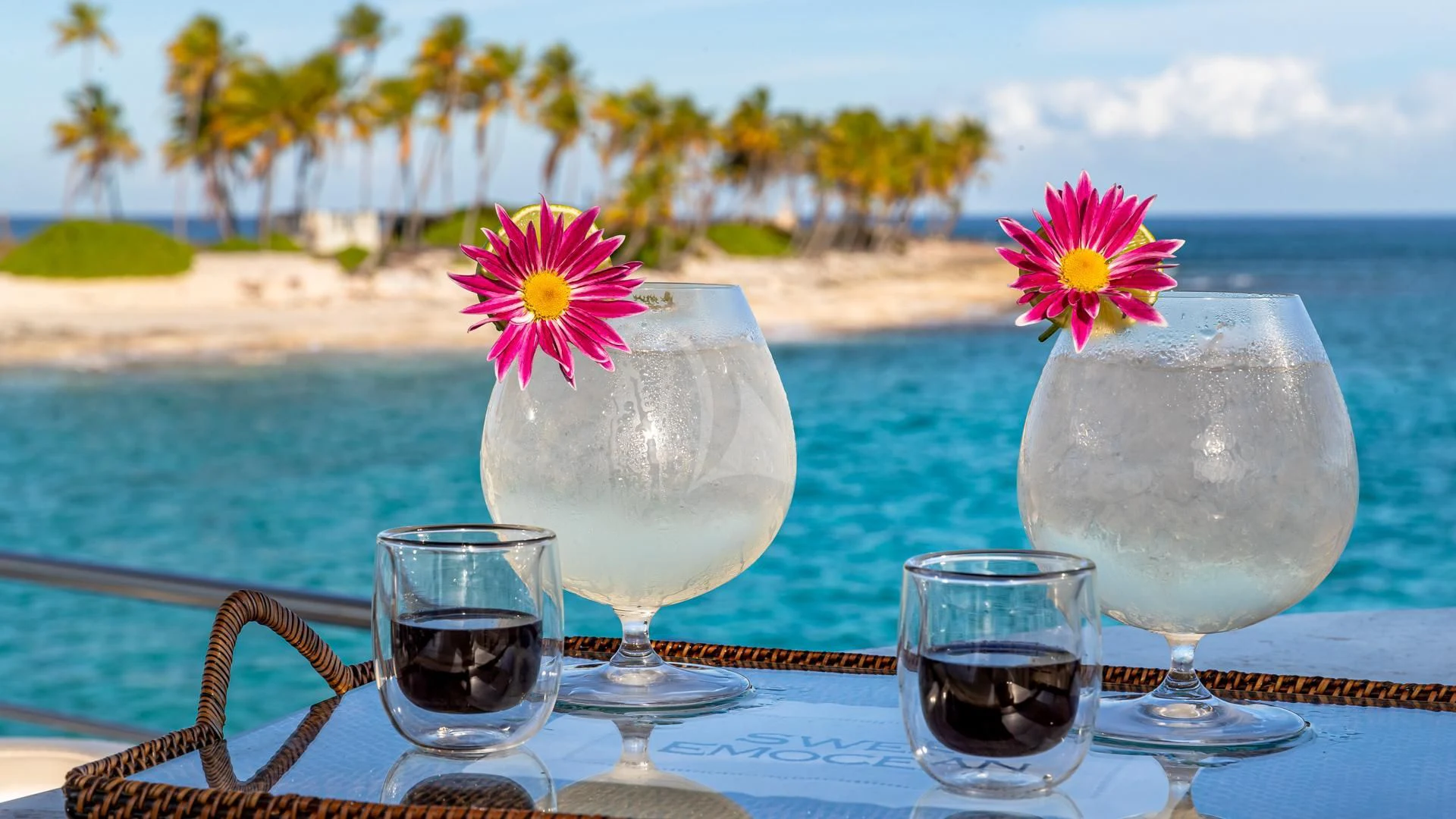 a group of glasses with liquid in them by a body of water aboard SWEET EMOCEAN Yacht for Sale