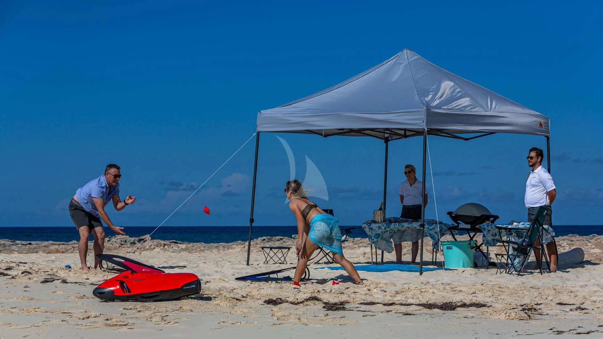 a group of people playing frisbee on a beach aboard SWEET EMOCEAN Yacht for Sale