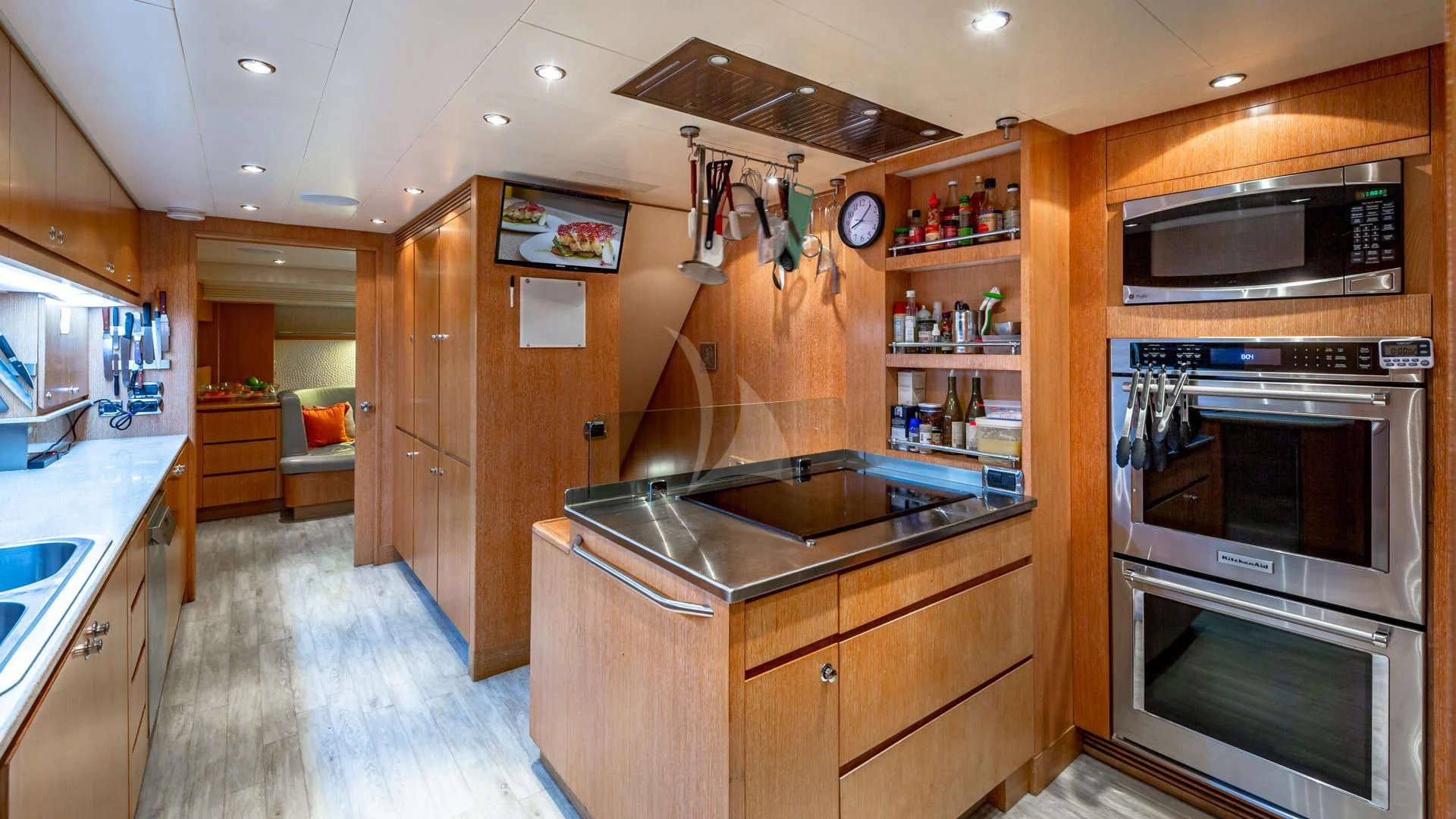 a kitchen with wooden cabinets aboard SWEET EMOCEAN Yacht for Sale