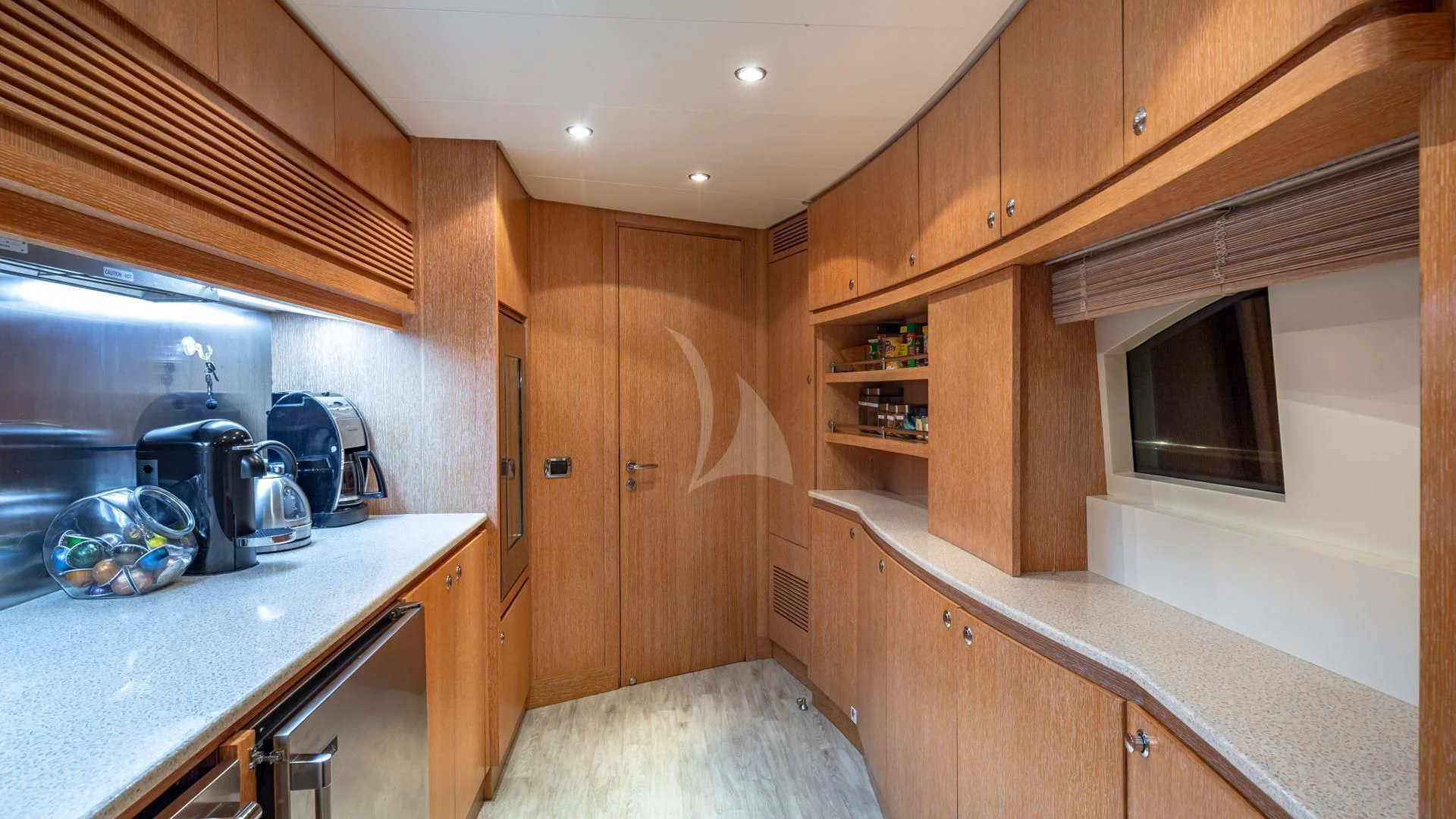 a kitchen with wooden cabinets aboard SWEET EMOCEAN Yacht for Sale
