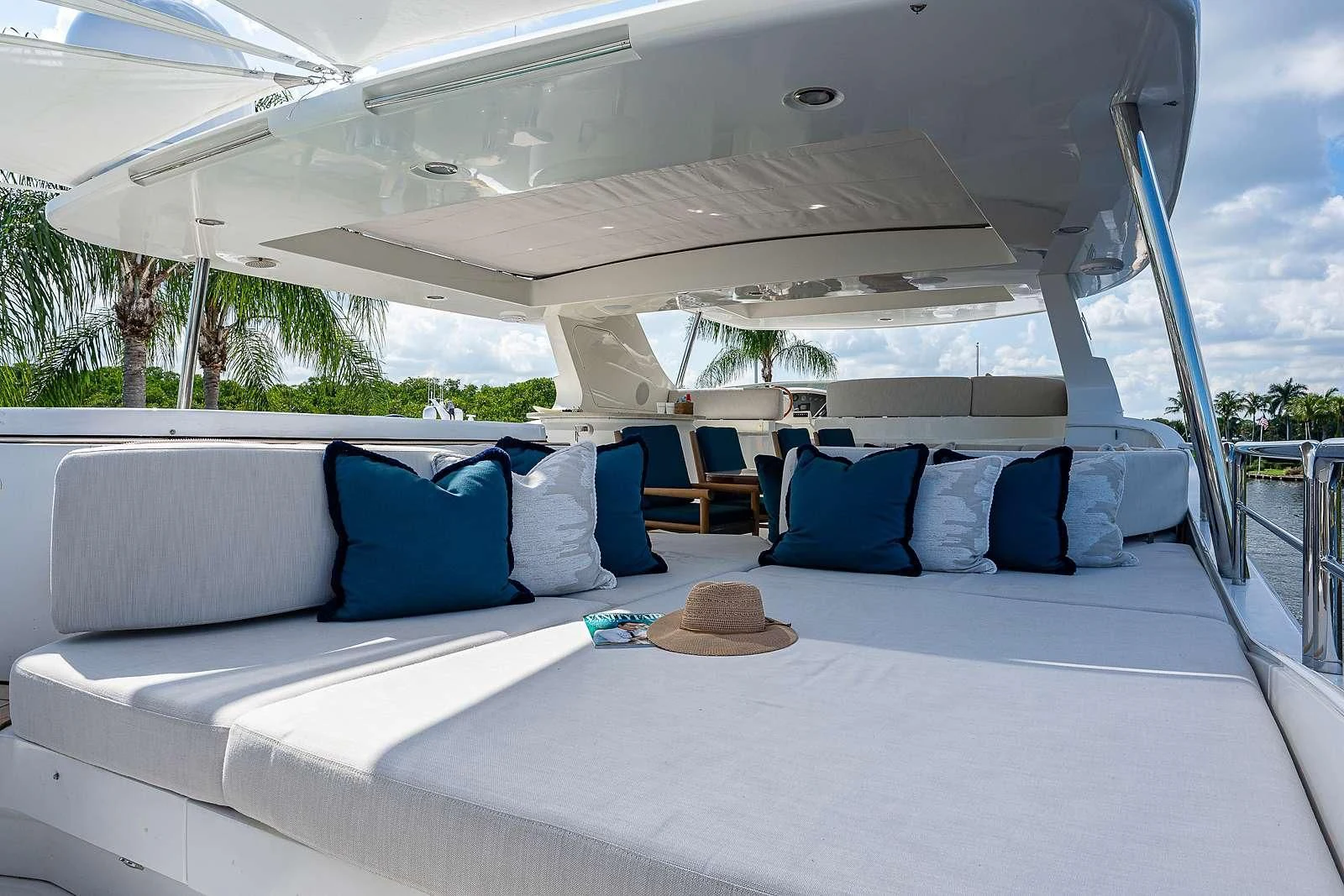 a white bed with blue pillows aboard SWEET EMOCEAN Yacht for Sale
