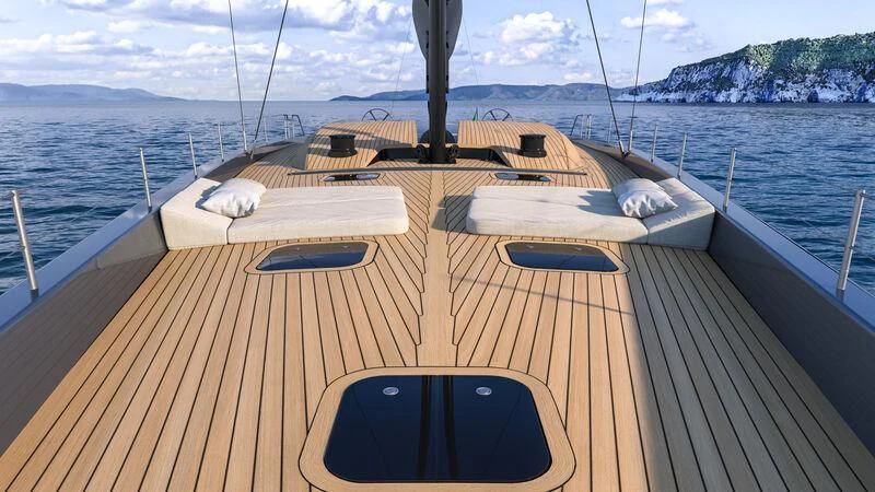 a deck with a view of the ocean and mountains aboard GALMA Yacht for Sale