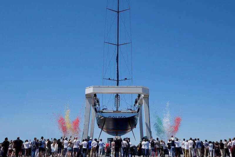 a group of people standing around a large object with flames coming out of it aboard GALMA Yacht for Sale