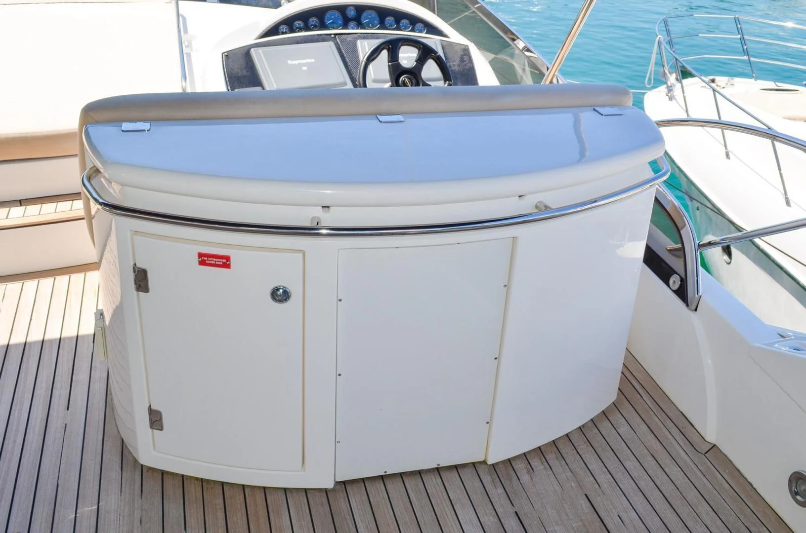 a white boat with a blue and white boat on a dock aboard PEARL Yacht for Sale