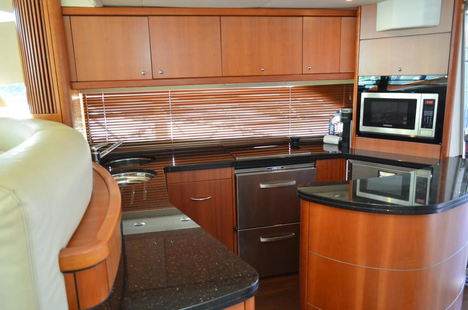 a kitchen with wooden cabinets aboard PEARL Yacht for Sale