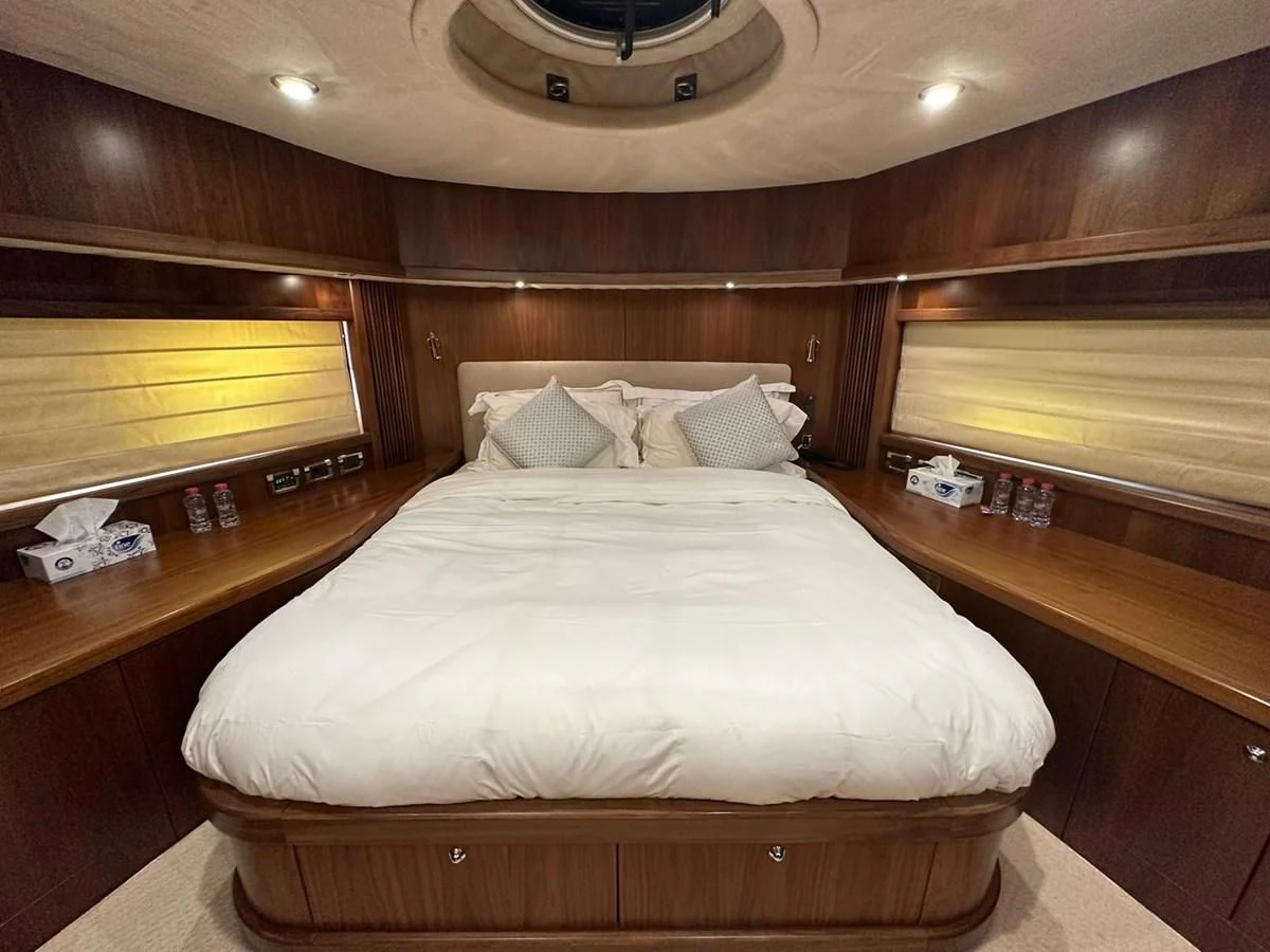 a bed with white sheets aboard MILA DUBAI Yacht for Sale