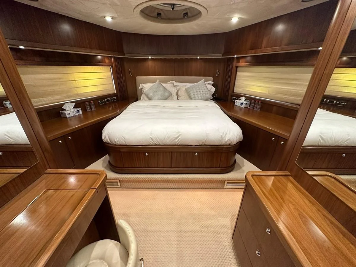 a bedroom with a bed and a desk aboard MILA DUBAI Yacht for Sale