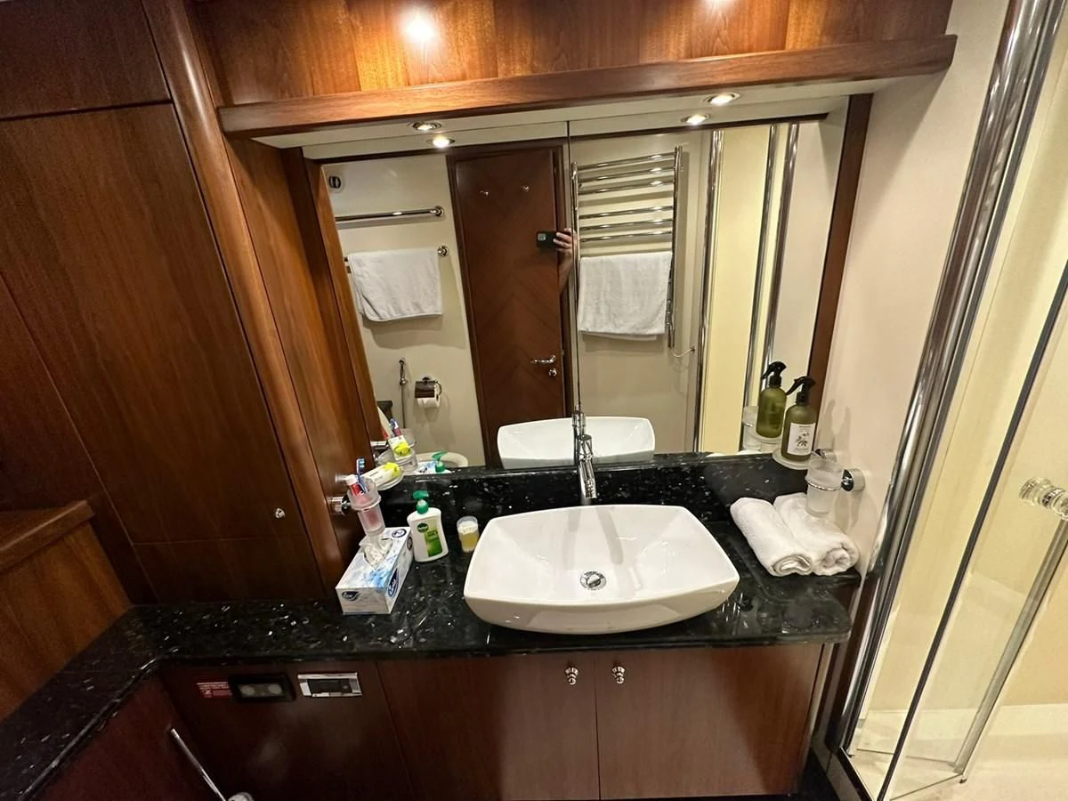a bathroom with a large mirror aboard MILA DUBAI Yacht for Sale
