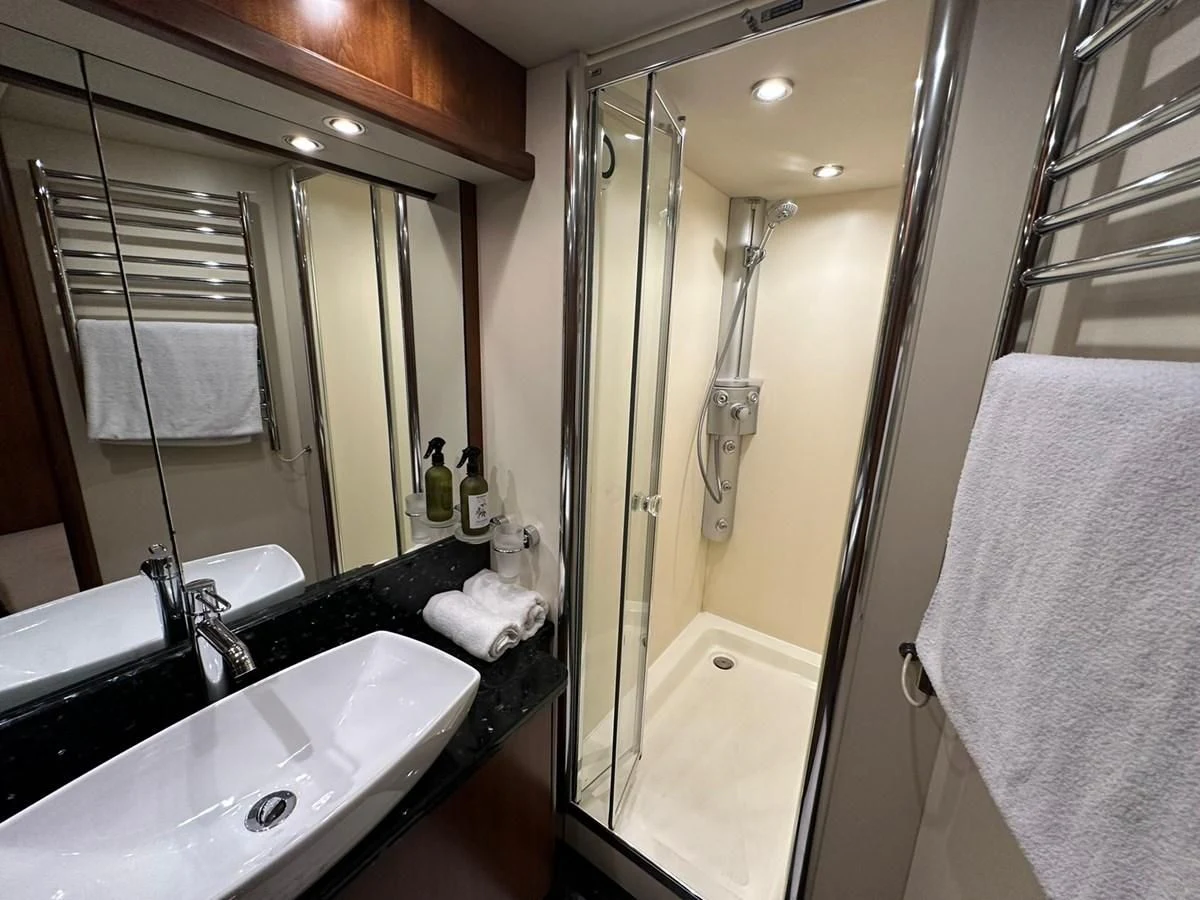 a bathroom with a large mirror aboard MILA DUBAI Yacht for Sale