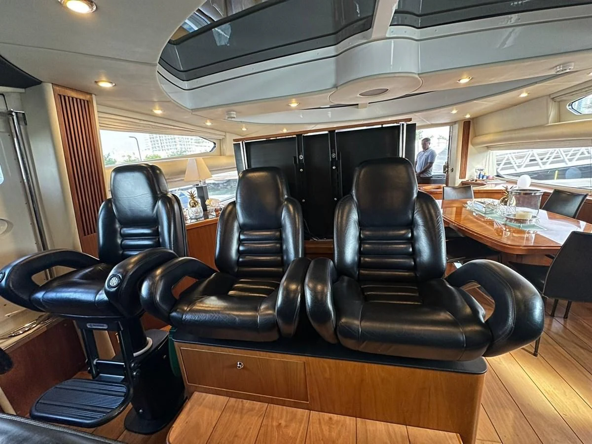 a room with chairs and a table aboard MILA DUBAI Yacht for Sale