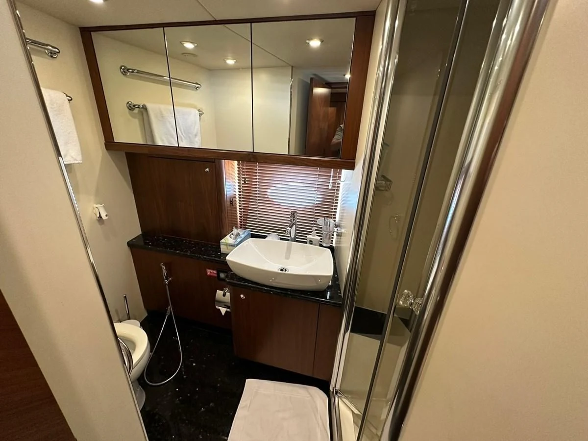 a bathroom with a glass shower aboard MILA DUBAI Yacht for Sale