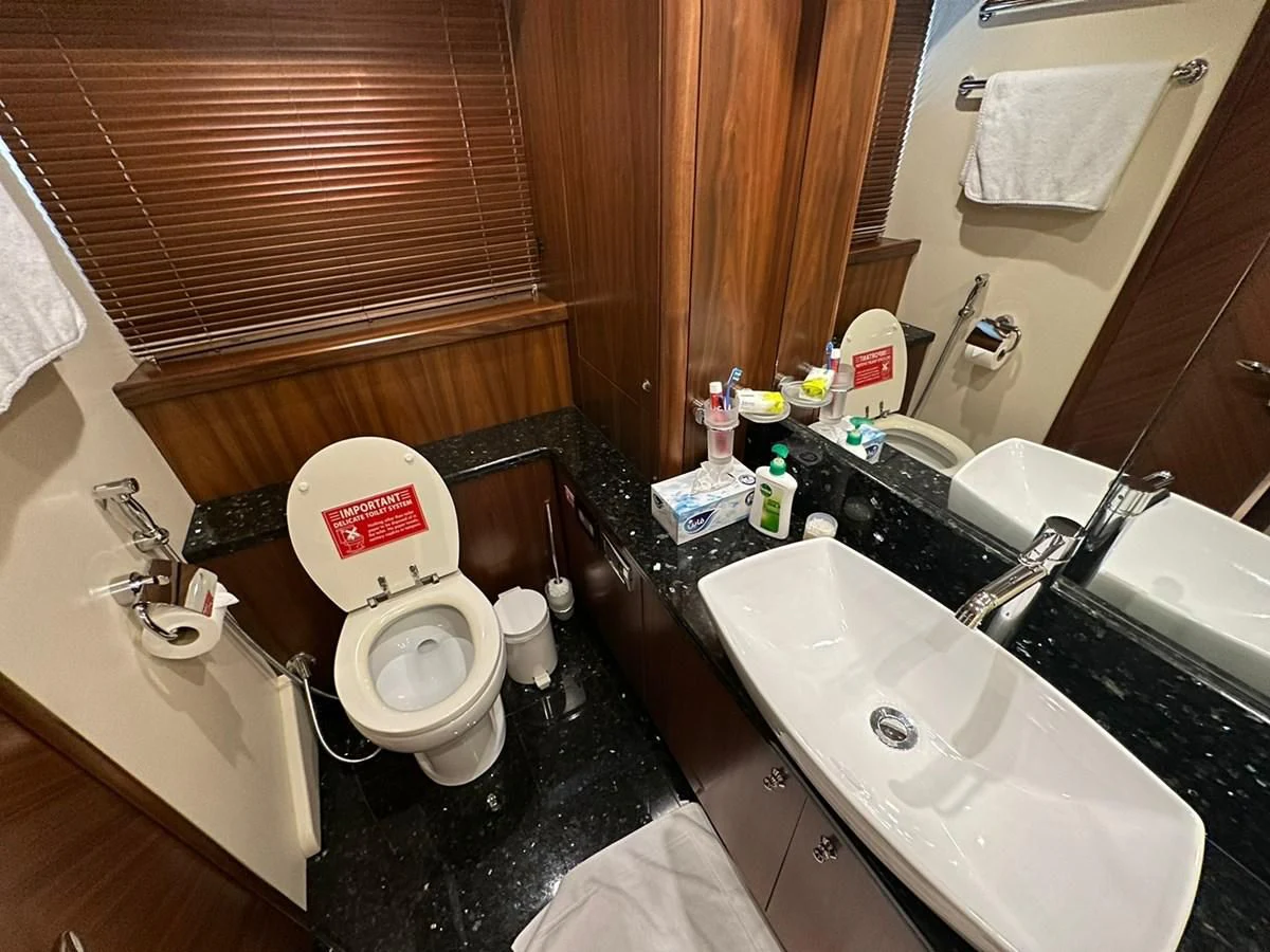 a bathroom with a toilet and sink aboard MILA DUBAI Yacht for Sale