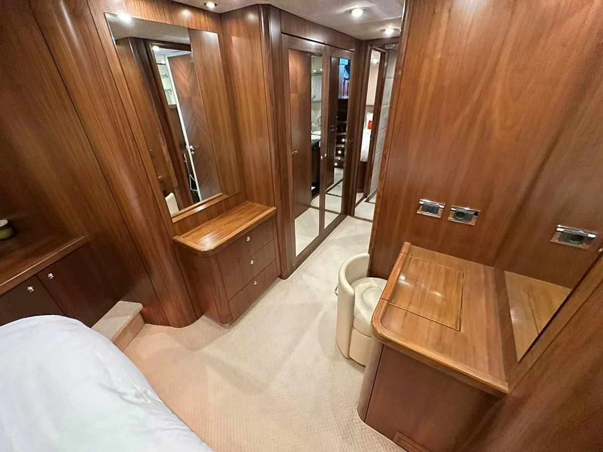 a room with a bed and a mirror aboard MILA DUBAI Yacht for Sale