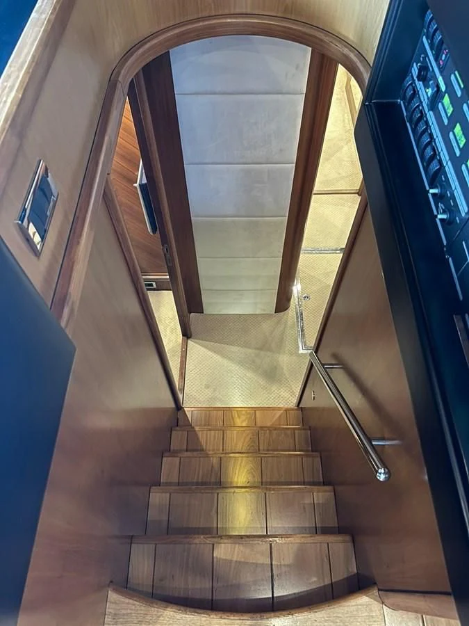 a staircase with a round window aboard MILA DUBAI Yacht for Sale
