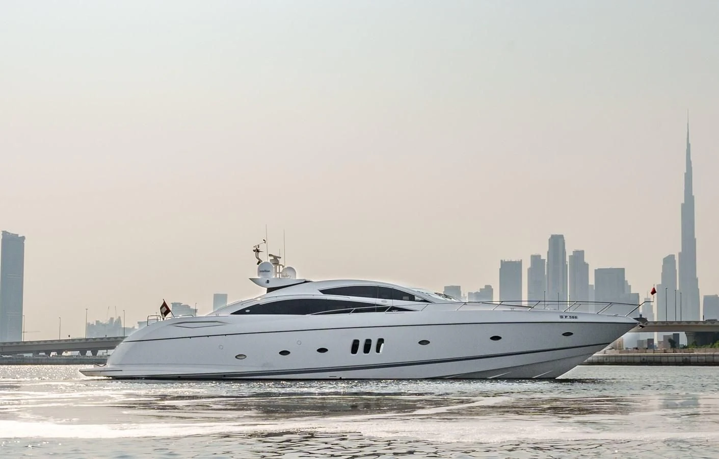 a white yacht on the water aboard MILA DUBAI Yacht for Sale