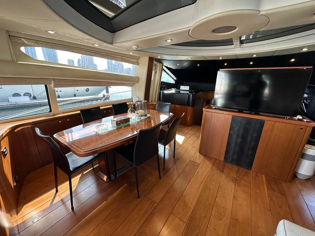 a room with a table and chairs aboard MILA DUBAI Yacht for Sale