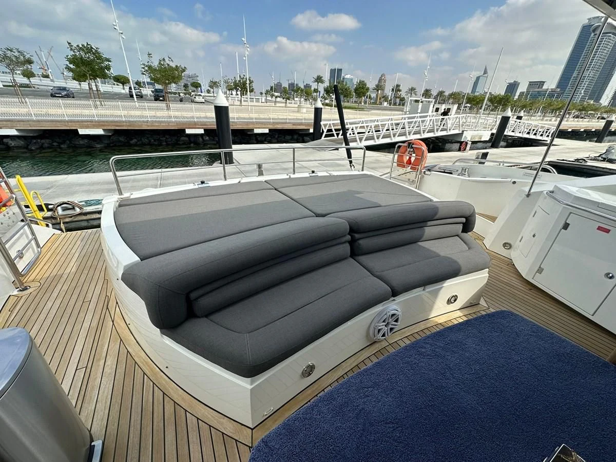 a deck with a pool and a deck with a building in the background aboard MILA DUBAI Yacht for Sale