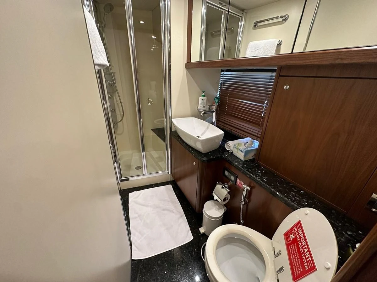 a bathroom with a toilet and a sink aboard MILA DUBAI Yacht for Sale