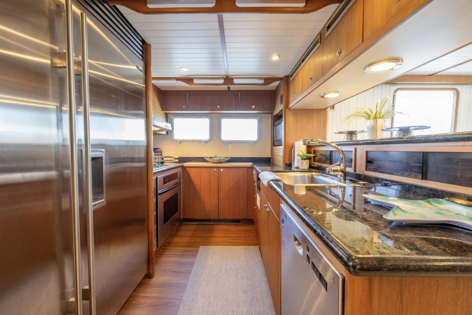 a kitchen with a large refrigerator aboard CHEEMAUN Yacht for Sale