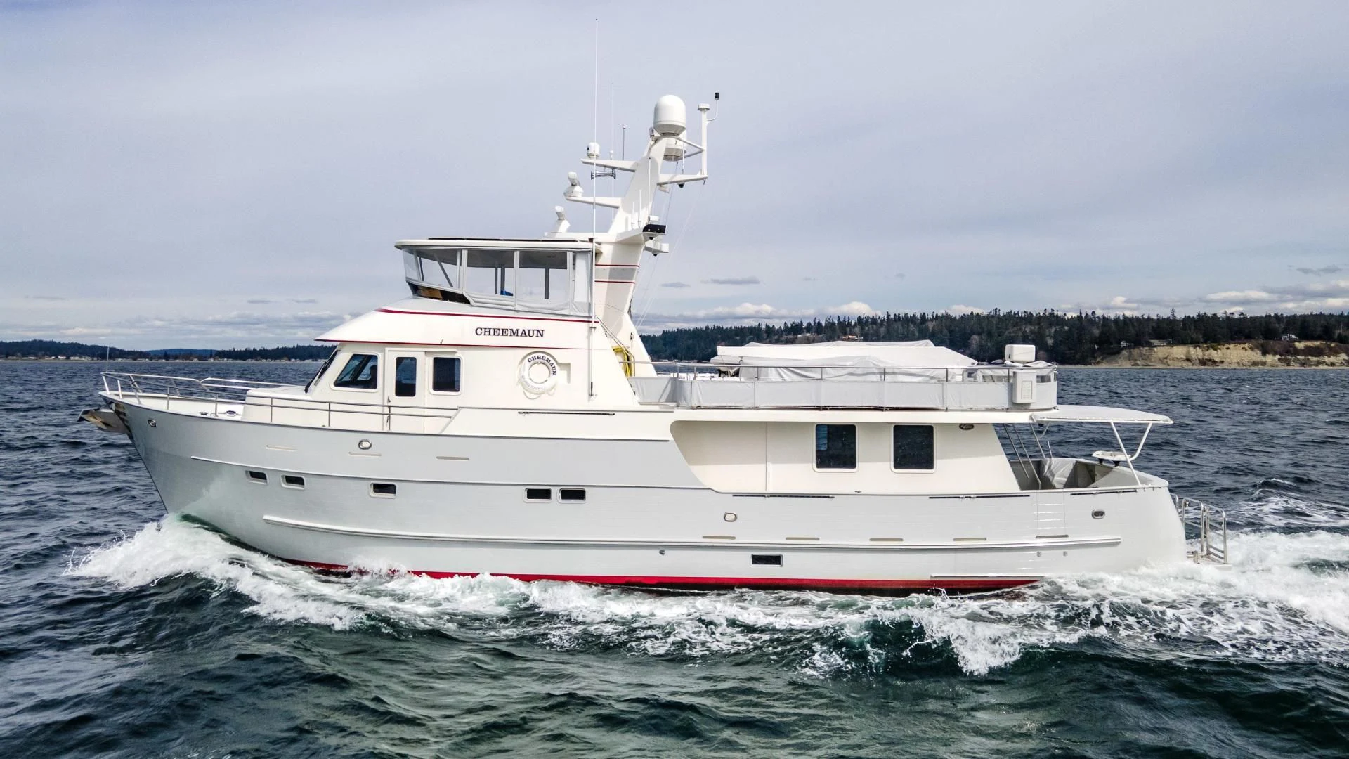 a white boat on the water aboard CHEEMAUN Yacht for Sale