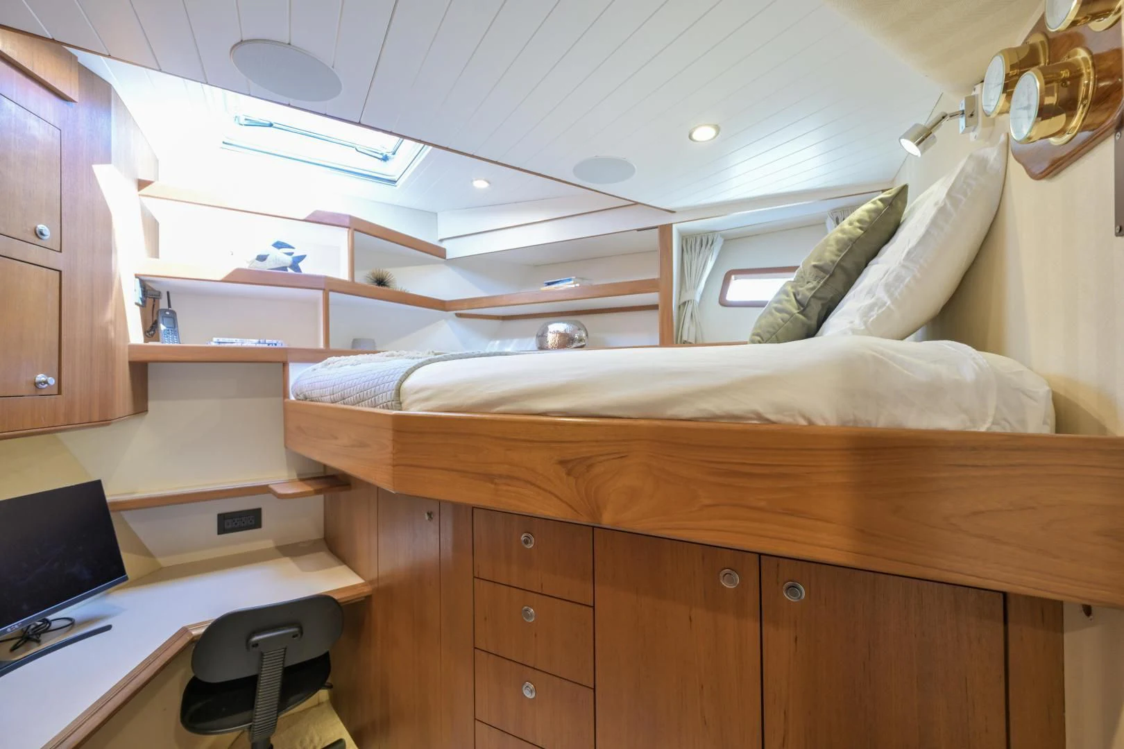 a bedroom with a bed and desk aboard CHEEMAUN Yacht for Sale