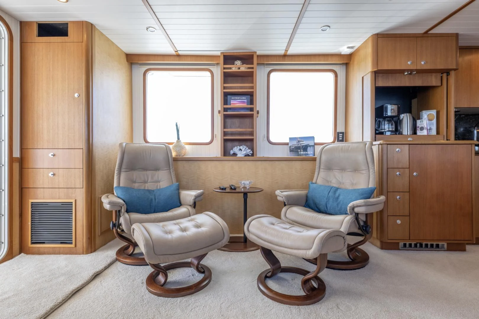 a room with a couple of chairs and a table aboard CHEEMAUN Yacht for Sale