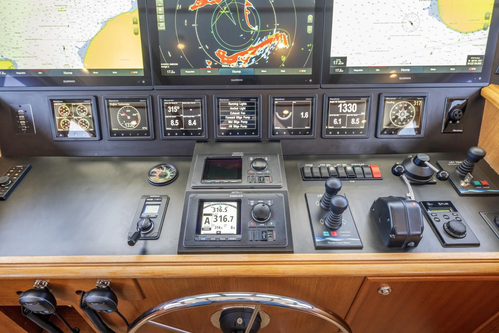 a control panel with a variety of buttons and dials aboard CHEEMAUN Yacht for Sale
