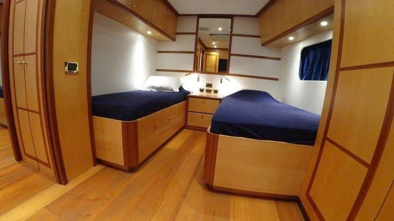 a room with a couple beds aboard ERAORA Yacht for Sale