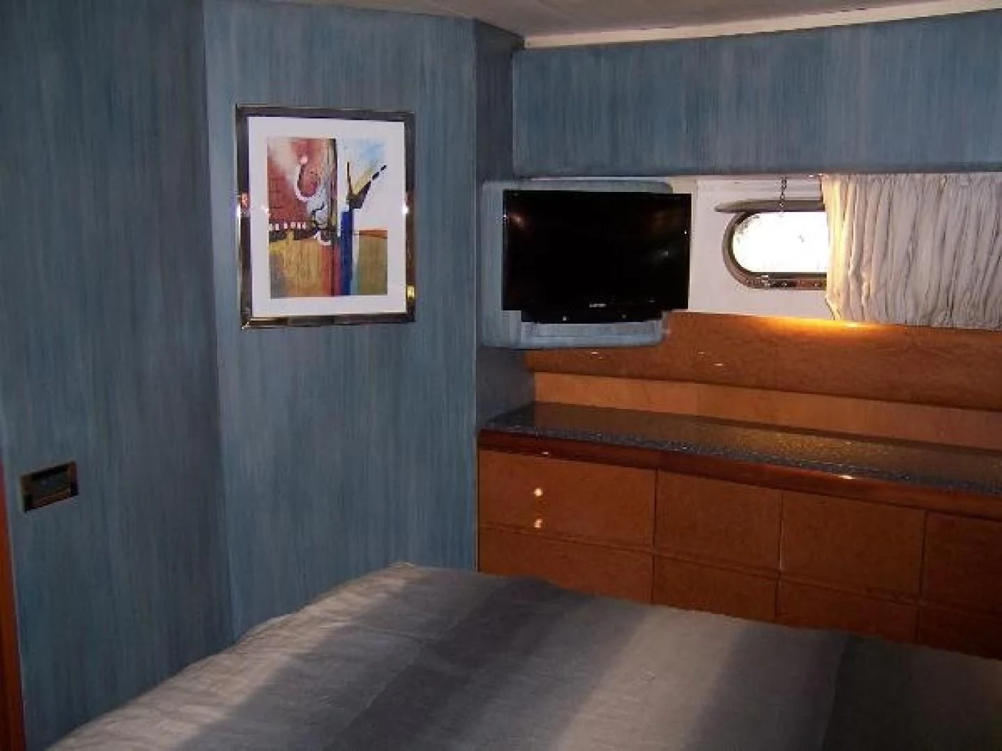 a bed with a television on it aboard UNZIPPED Yacht for Sale