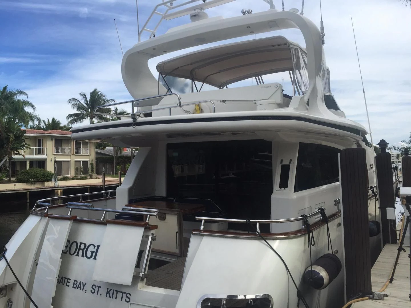 a boat with a canopy aboard UNZIPPED Yacht for Sale