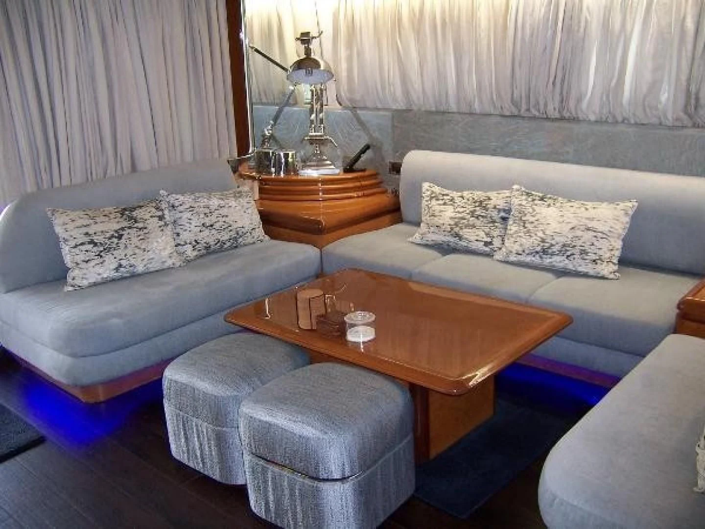 a living room with a couch and coffee table aboard UNZIPPED Yacht for Sale