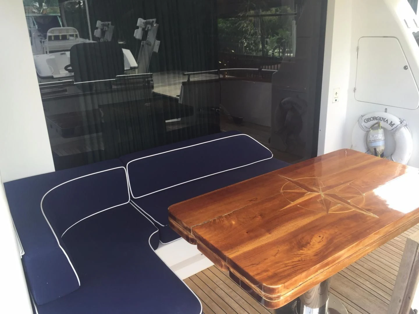 a table with a fan and a fan aboard UNZIPPED Yacht for Sale