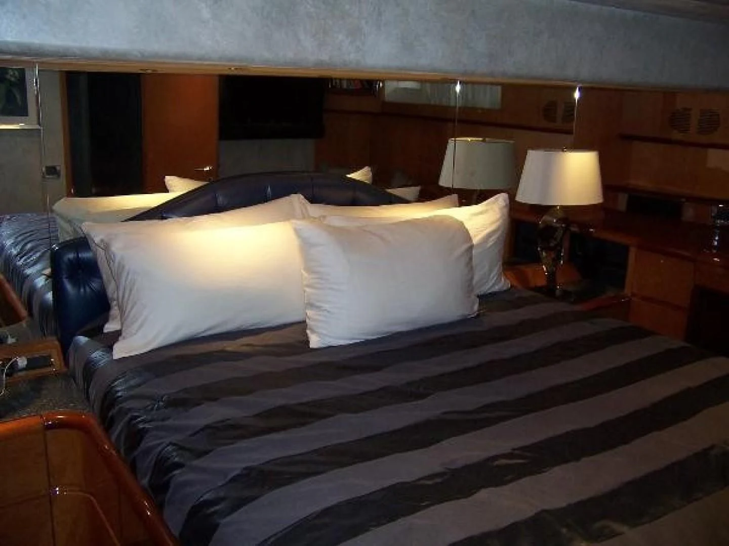 a bed with a black and white checkered bed spread aboard UNZIPPED Yacht for Sale