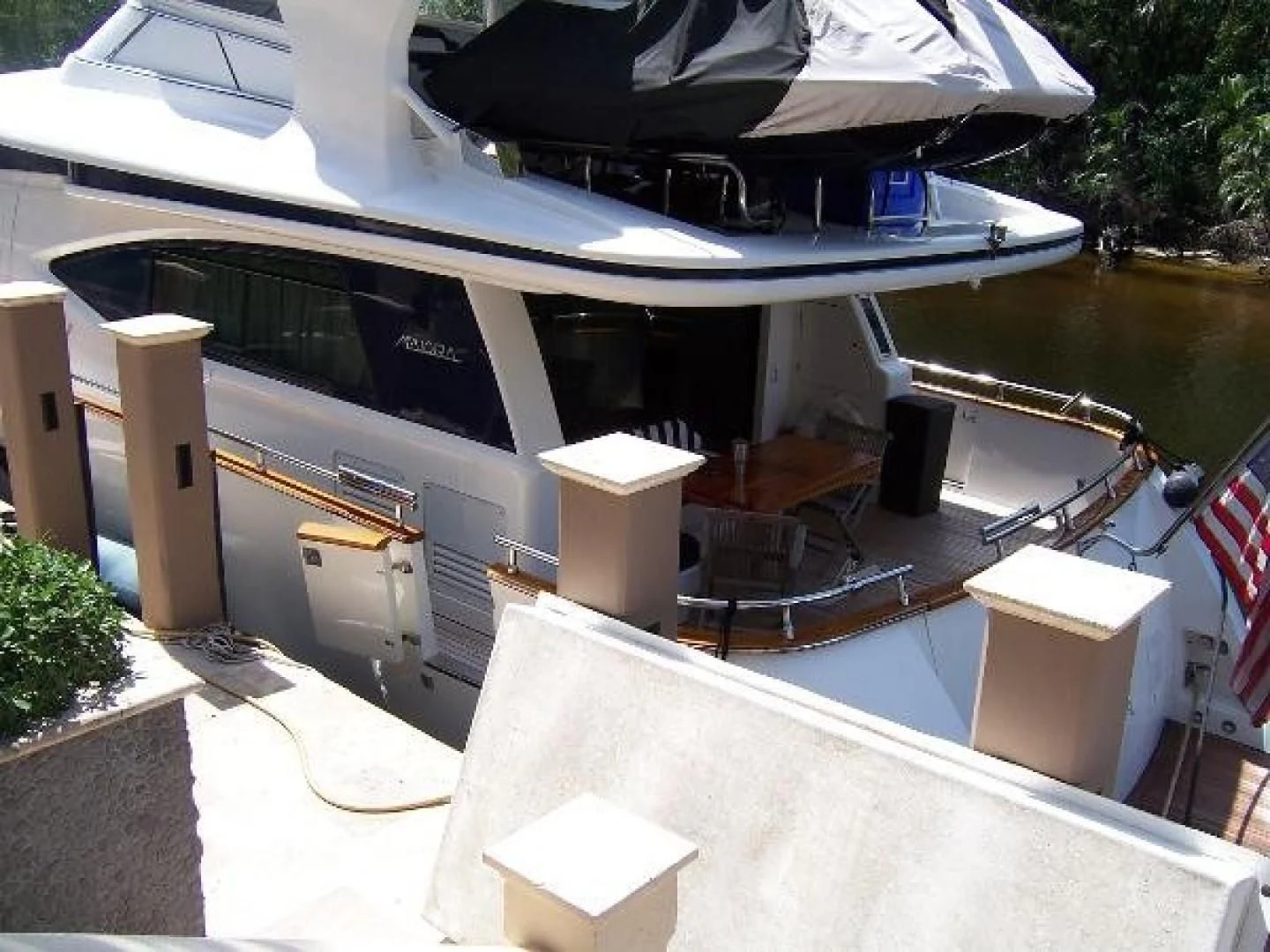 a building with a large deck and a pool aboard UNZIPPED Yacht for Sale