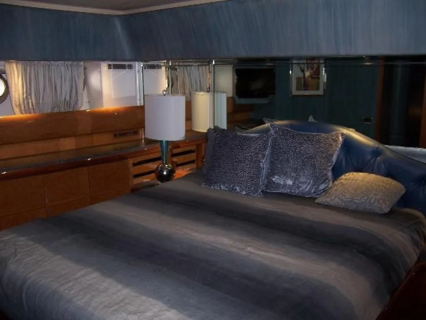 a bed with blue sheets aboard UNZIPPED Yacht for Sale