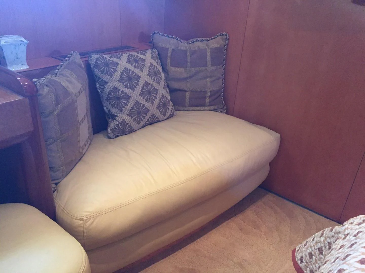 a couch with pillows aboard UNZIPPED Yacht for Sale