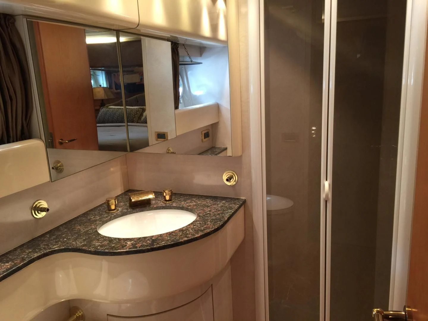 a bathroom with a sink and a large mirror aboard UNZIPPED Yacht for Sale