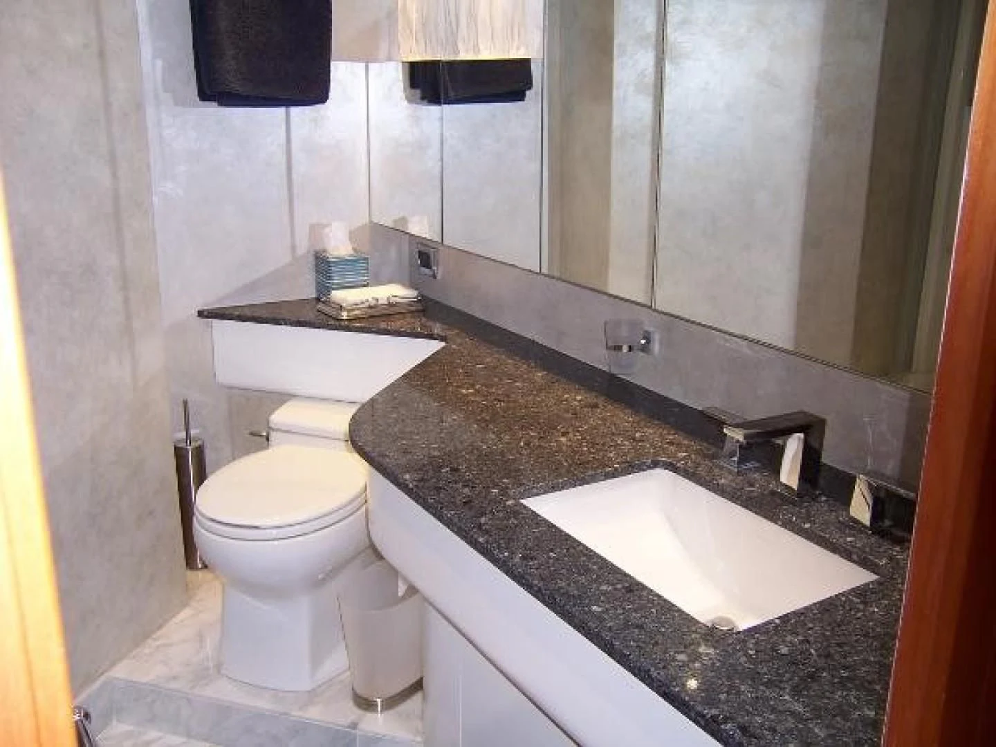 a bathroom with a sink and a toilet aboard UNZIPPED Yacht for Sale