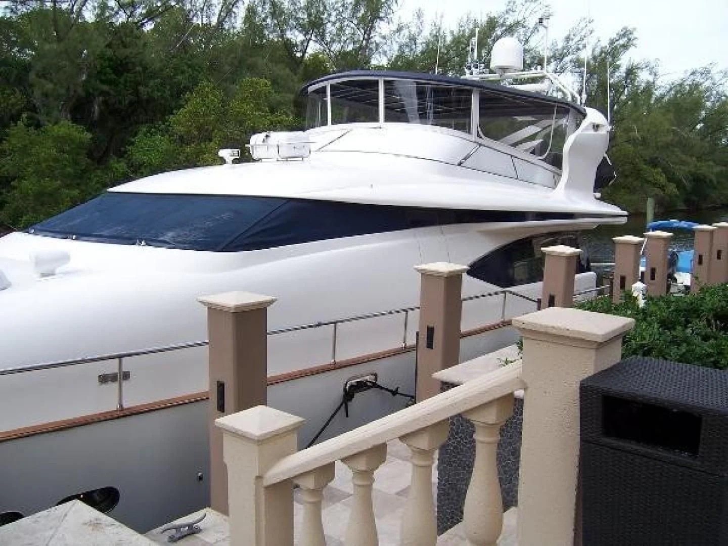 a white boat on a dock aboard UNZIPPED Yacht for Sale