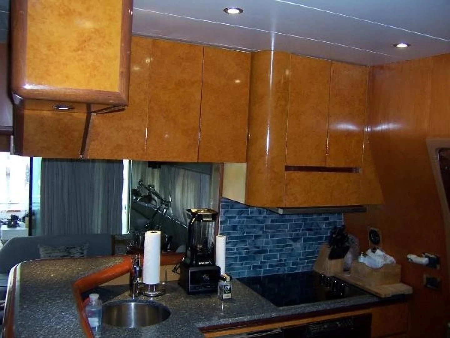 a kitchen with wooden cabinets aboard UNZIPPED Yacht for Sale