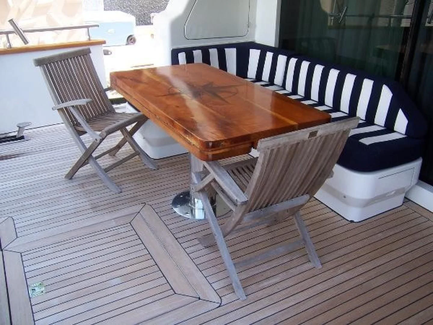 a table and chairs on a deck aboard UNZIPPED Yacht for Sale