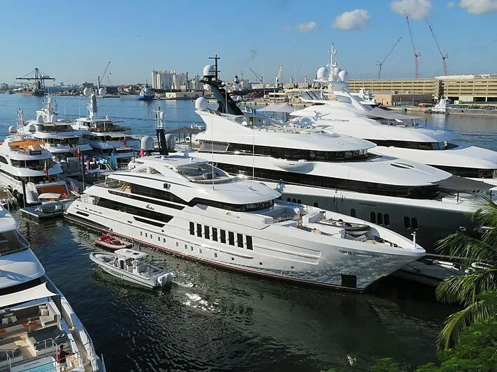 a large white yacht in a harbor aboard VIDA Yacht for Sale